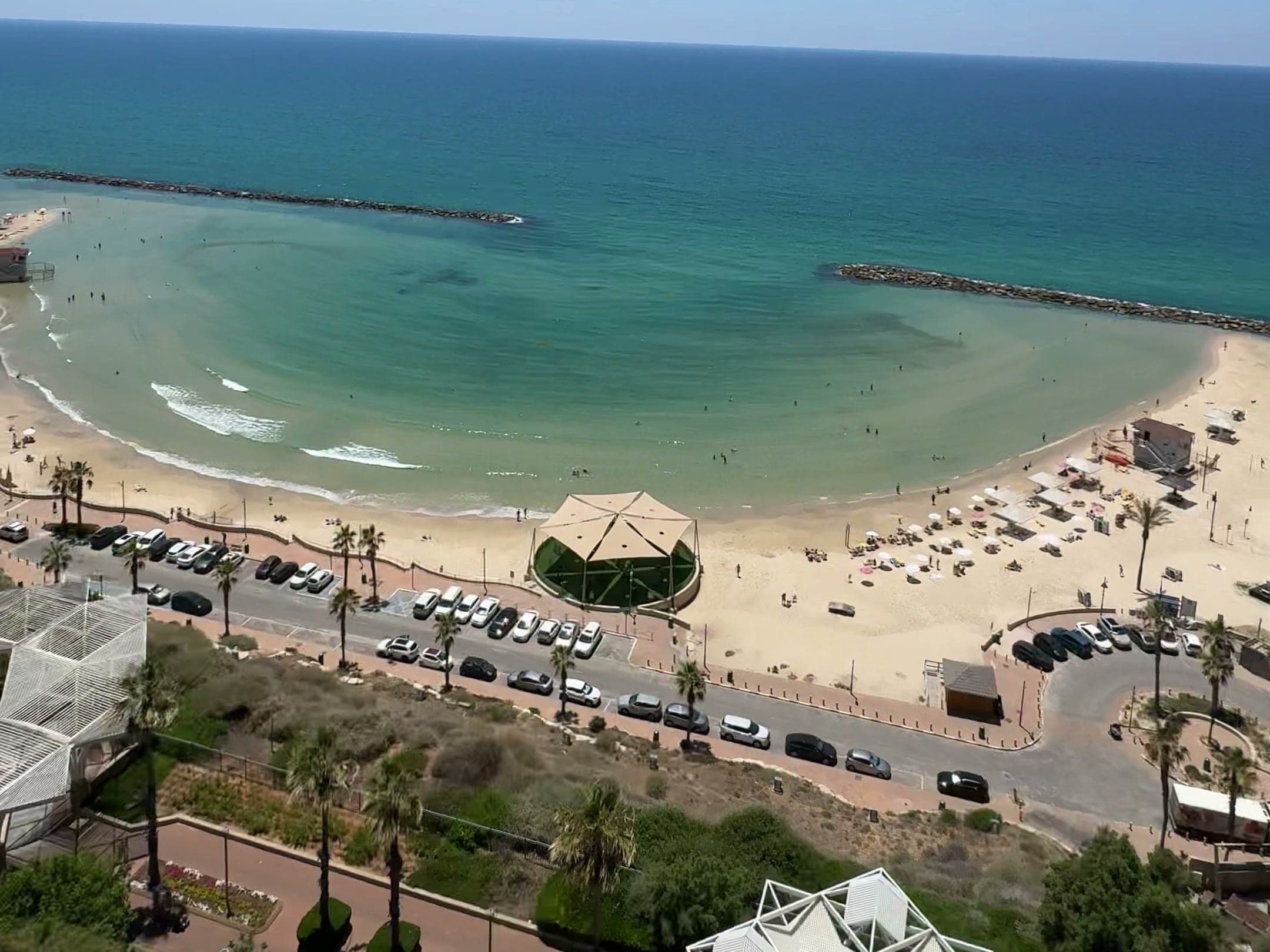The clifftop park and promenade, the beach and breakwaters of Netanya, seen from the SEA VIEW rooftop