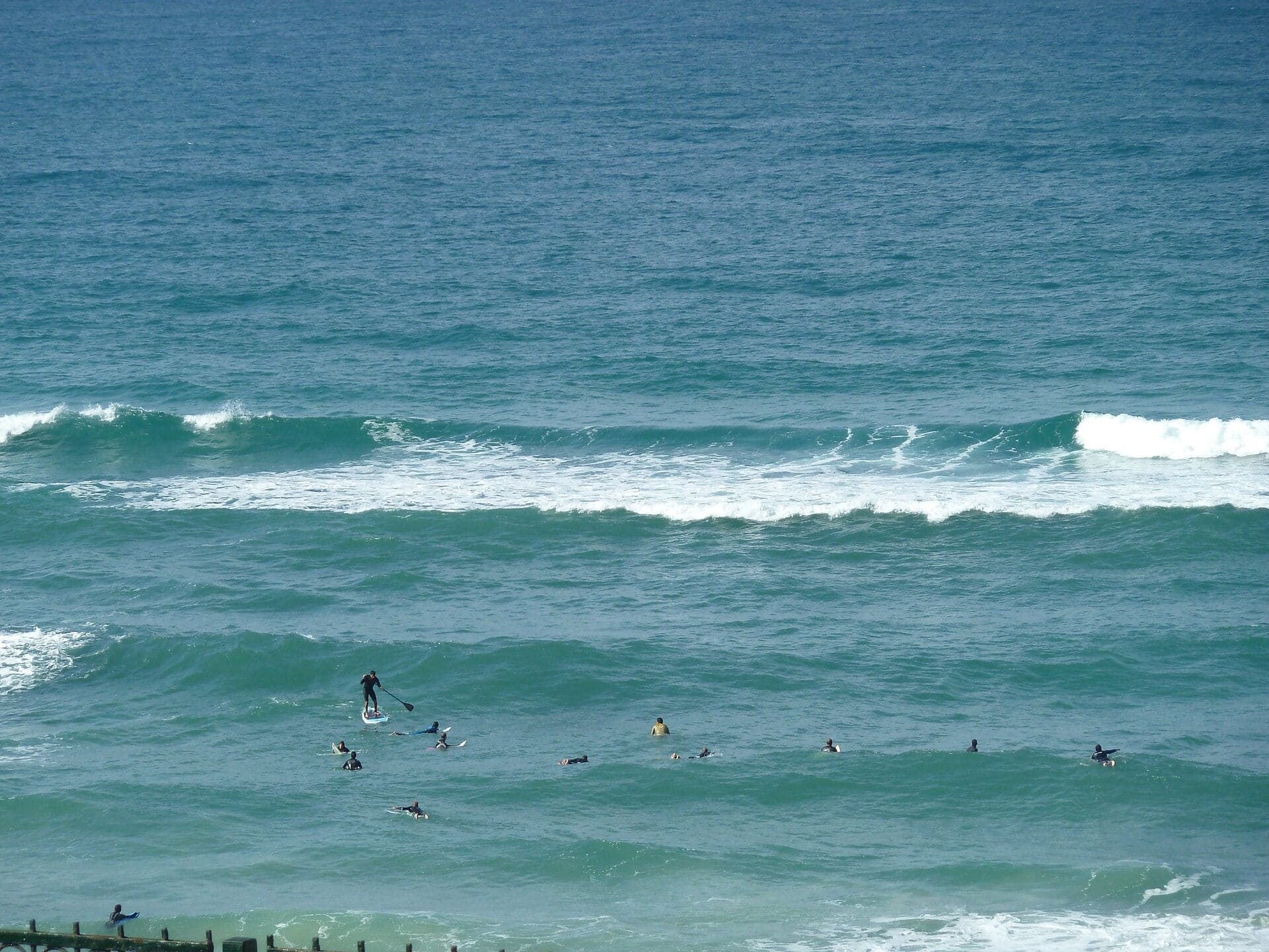 Surfers in the waves off Netanya's beaches